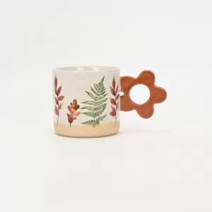 floral handle ceramic mug, nature-inspired coffee mug, botanical print ceramic cup, rustic clay texture mug, plant-themed tea mug, aesthetic nature mug
