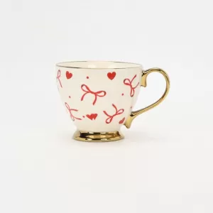 bow mug, polka dot ceramic mug, gold-plated handle mug, elegant coffee cup, cute bow design mug, luxury ceramic mug, stylish mug with gold handle, refined coffee cup, decorative ceramic mug, gift mug 