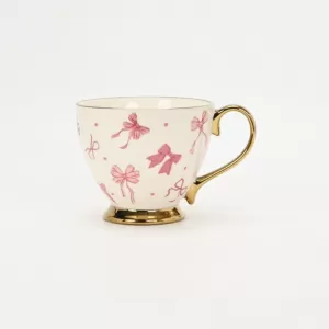bow mug, polka dot ceramic mug, gold-plated handle mug, elegant coffee cup, cute bow design mug, luxury ceramic mug, stylish mug with gold handle, refined coffee cup, decorative ceramic mug, gift mug 